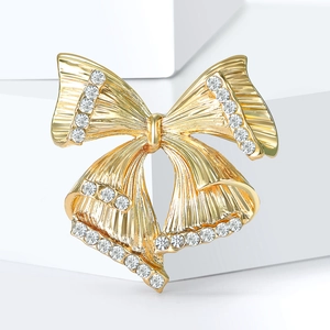 Broche nœud dorée élégante avec strass brillants et texture métallique pour femmes
