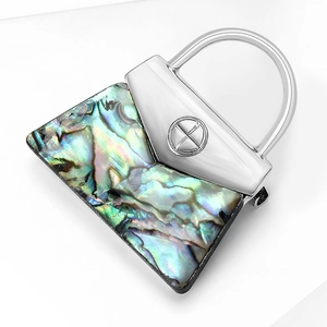Elegant abalone shell handbag brooch with iridescent colors and silver metal details