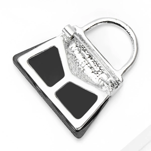 Modern silver handbag brooch with black enamel inlay and secure metal pin clasp