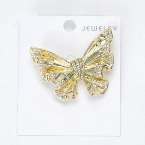 Detail of creative butterfly brooch with micro-pave cubic zirconia and golden texture