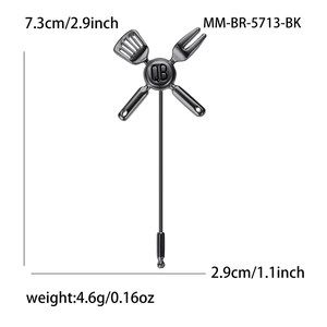 Black alloy kitchenware brooch with crossed spatula and fork design and QB engraving