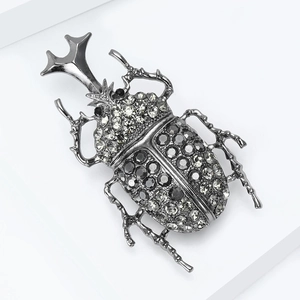 Vintage beetle brooch with sparkling rhinestones on a sleek gunmetal gray finish