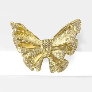 Elegant butterfly brooch in gold with micro-pave cubic zirconia on a white stand