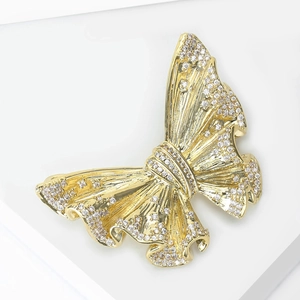 Exquisite golden butterfly brooch with micro-paved zircons and textured wings on white stand