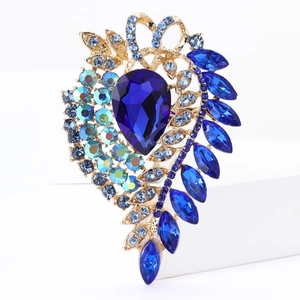 Macro detail of luxury vintage brooch featuring blue crystals and gold alloy setting