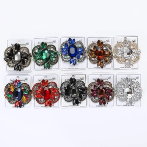 Detailed macro view of ten assorted crystal flower brooches with colorful rhinestones