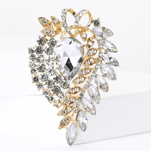 Detailed close-up of a crystal drop brooch with gold plating and sparkling rhinestones