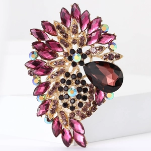 Detail of flower brooch with purple marquise gems and a large pear-shaped brown stone