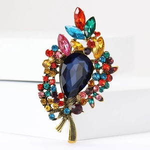 Vintage-Brosche aus Gold mit großem birnenförmigem blauem Kristall und Strasssteinen