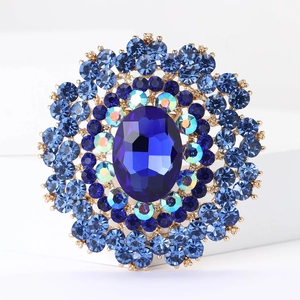 Macro shot of luxury vintage large blue crystal flower brooch with faceted blue gems