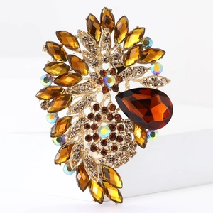 Detailed view of amber crystal flower brooch with shimmering gold metal setting