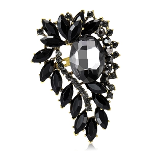 Elegant vintage alloy brooch with black rhinestone crystals and gold plating on white backdrop