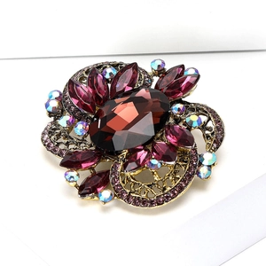 Vintage gold brooch with deep red oval gem, pink marquise stones and rainbow rhinestones