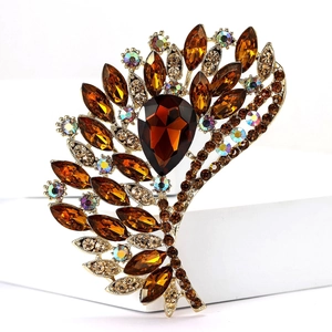 Macro shot of vintage amber glass brooch with iridescent rhinestones on a white stand