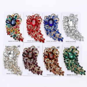 Macro view of vintage alloy large glass brooches with teardrop and oval crystal details