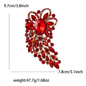 Detailed view of a vintage large red glass brooch with gold metal frame and size specs