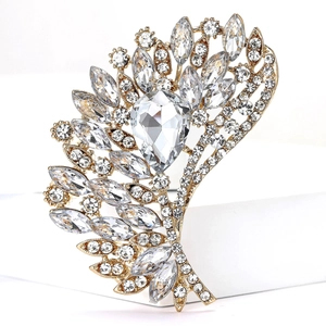 Detailed close-up of a vintage golden alloy brooch with sparkling rhinestone crystals