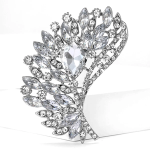 Macro detail of luxury silver alloy brooch with large pear-cut crystal and rhinestones