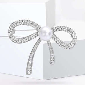 Élégante broche nœud argentée ornée de perles blanches et de strass scintillants