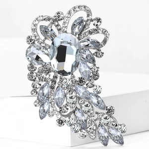 Detailed macro view of large glass brooch with silver base and sparkling crystal flower design