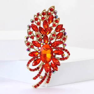 Vintage-Goldbrosche mit großem orangefarbenem Kristall und roten Strasssteinen