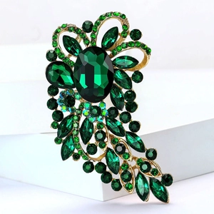 Exquisite gold alloy brooch featuring oversized dark green gemstones in a floral design