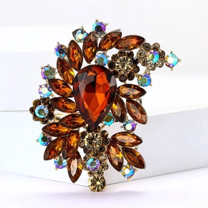 Macro shot of retro gold alloy brooch featuring amber crystals and aurora borealis stones