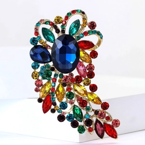 Elegant gold alloy brooch featuring large blue gemstone and multi-color rhinestones