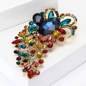 Luxurious gold-plated brooch with large blue gems and colorful crystal rhinestones