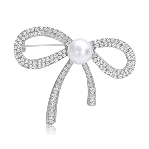 Broche nœud argentée tendance ornée de strass étincelants et d'une perle blanche centrale