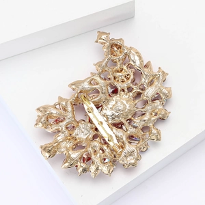 Detailed back view of a large vintage alloy brooch featuring a secure gold pin fastener