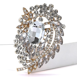 Detailed macro shot of vintage alloy brooch with elegant crystal clusters and a large gemstone