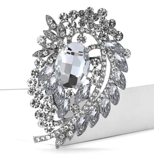 Macro shot of large crystal glass brooch with rhinestone flower pattern in silver finish