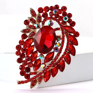 Vintage gold-toned brooch with large oval red gemstone and colorful crystal accents