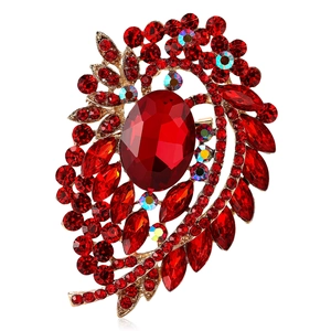 Exquisite golden alloy flower brooch featuring large red rhinestones and crystals