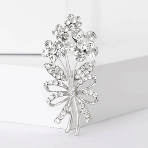 Detailed view of silver flower bouquet brooch with sparkling crystal rhinestones and bow