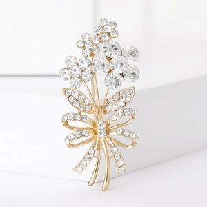 Elegant gold flower bouquet brooch with sparkling crystals and a rhinestone bow detail