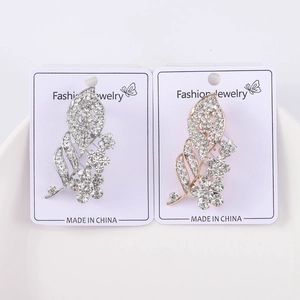 Close-up of sparkling rhinestone flower leaf brooches on fashion jewelry display cards