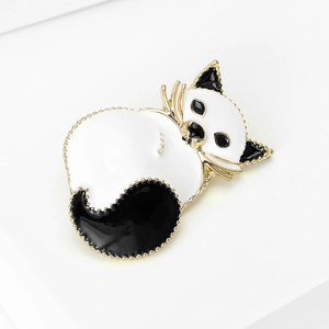 Charming enamel sleeping cat brooch in black and white with gold-tone beaded metal edges