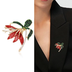 Elegant narcissus flower brooch with red and green crystals on a black suit jacket