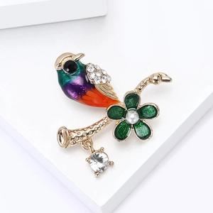 Charming enamel bird brooch with crystals and pearls on a gold branch detail