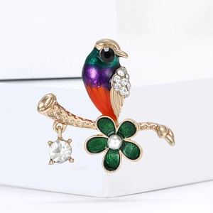 Colorful enamel hummingbird brooch with crystal wings and pearl flower on a branch