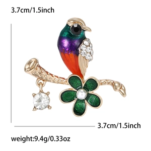 Colorful hummingbird brooch pin with crystal rhinestones on a gold branch with pearl