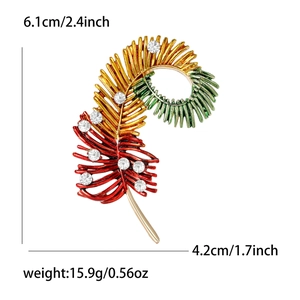 Fashion feather brooch with colorful crystals and pearls showing 6.1cm by 4.2cm dimensions