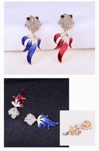 Détails de la broche poisson rouge avec strass brillants et finition en émail coloré