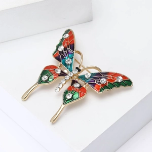 Broche papillon vintage dorée avec ailes en émail coloré et cristaux brillants