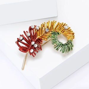 Elegant feather brooch with vibrant tricolor gradient finish and crystal accents