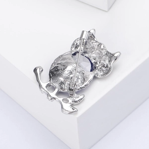 Detailed back view of an owl brooch pin made of vintage silver-tone metal alloy