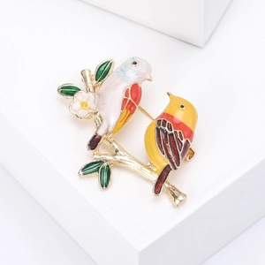 Exquisite enamel bird brooch featuring two colorful birds on a golden branch with white flower