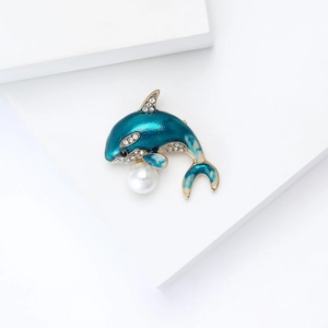 Prachtige blauwe emaille orka speld met kristallen en een parel op een witte achtergrond